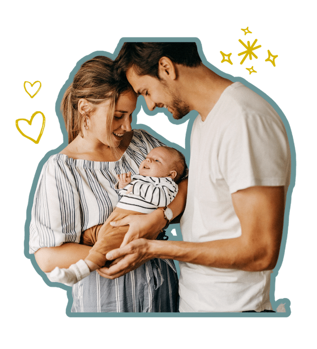 A woman and man smiling and holding their baby together