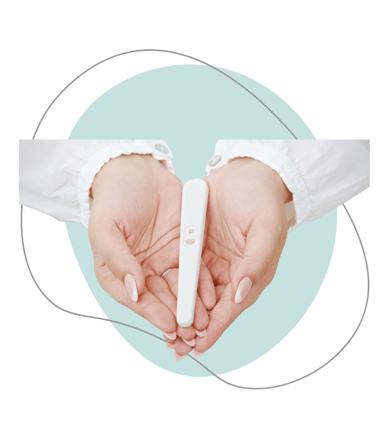 A close up of a woman's hands holding a pregnancy test